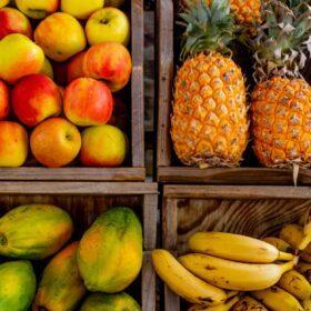 four trays of varieties of fruits